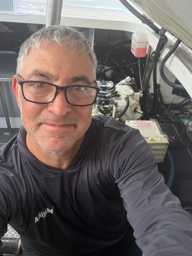 Captain Javier beside onboard mechanical equipment